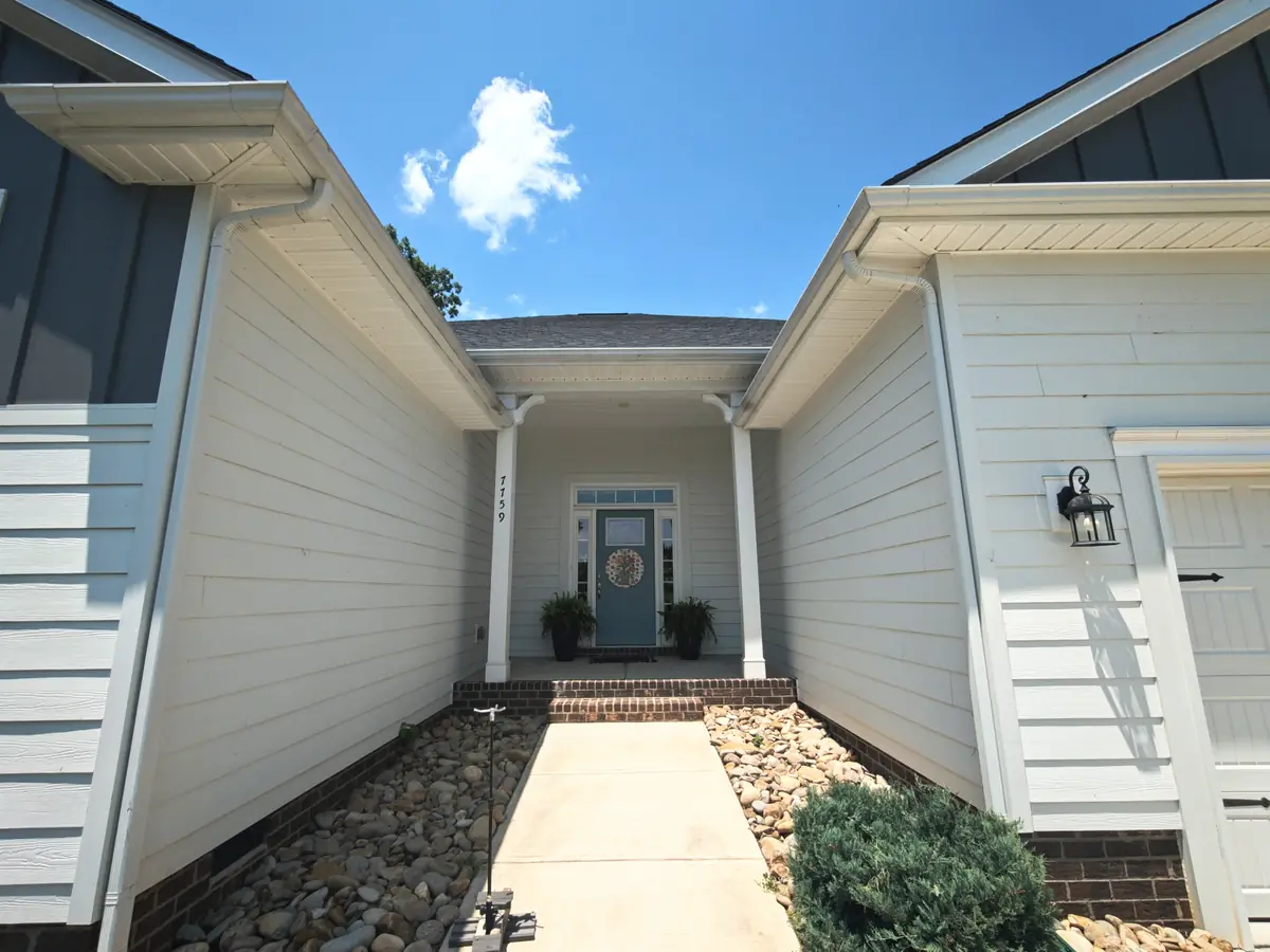 Clean white siding, trim and covered front entry on a home near Locust, NC after a house soft wash