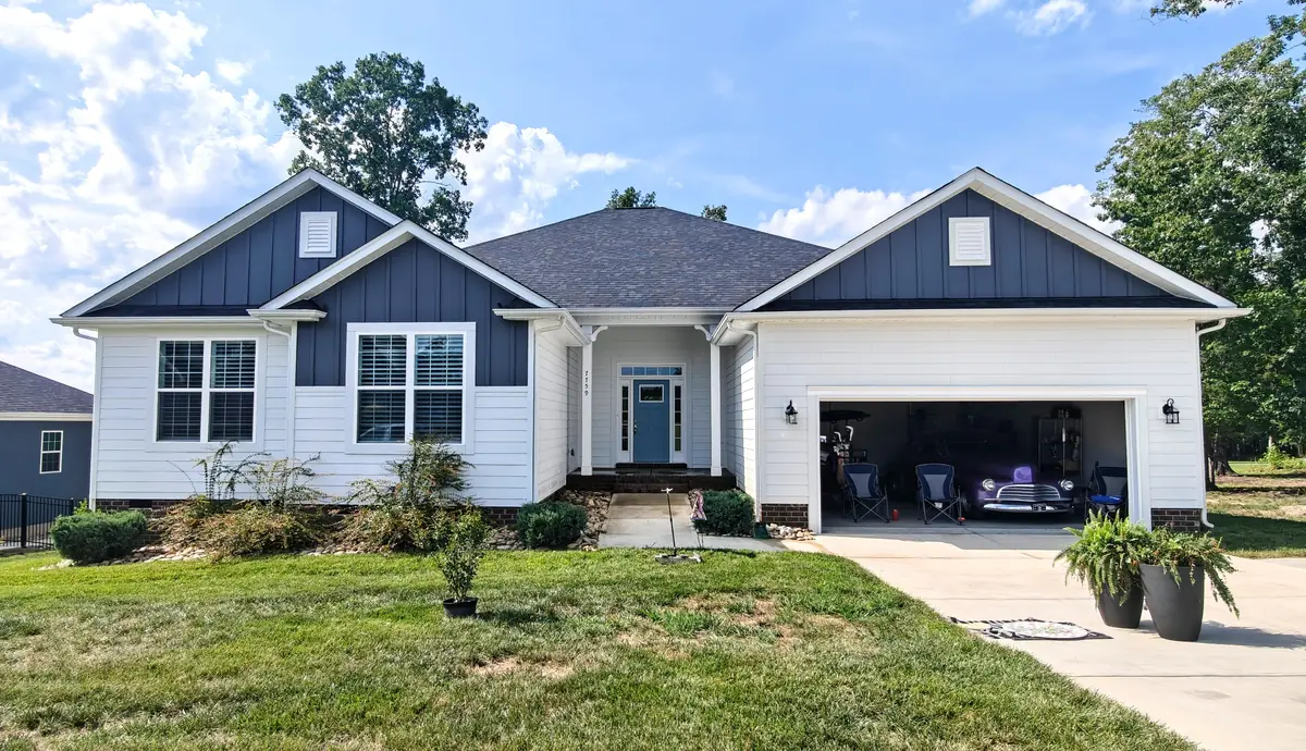 Craftsman-style home near Locust, NC with a clean dark shingle roof and freshly washed siding