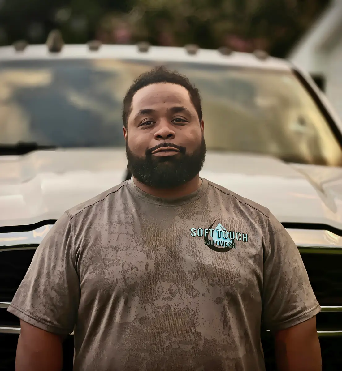 J Med, owner and operator of Soft Touch Softwash, standing in front of the service truck