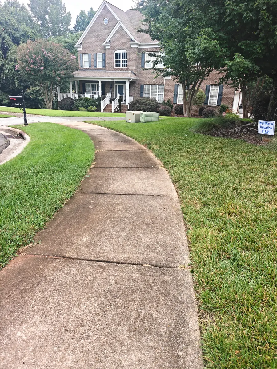 Front walkway stained with dirt and algae before pressure washing in Concord, NC